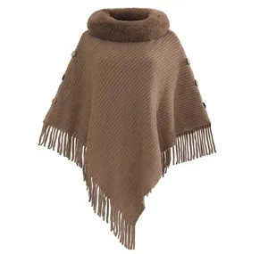 Brown knit poncho featuring a faux fur collar and decorative side buttons with tassels