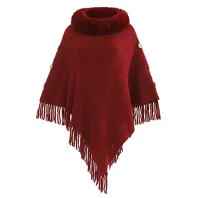 Close-up of women's knitted poncho with faux rabbit fur collar and fringe hem
