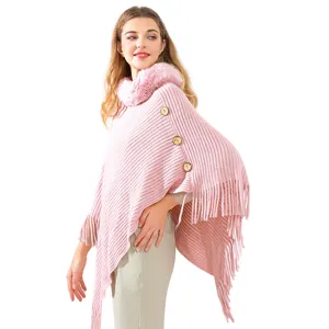 Elegant pink knitted poncho for women with faux fur collar and fringe detailing