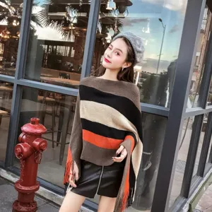 Stylish striped asymmetrical poncho shawl with tassels for women, autumn fashion lifestyle look.
