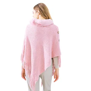 Elegant pink knitted poncho featuring a faux fur collar and stylish tassels for women