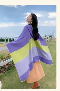 Woman wearing a colorful striped ethnic poncho shawl in an outdoor travel setting