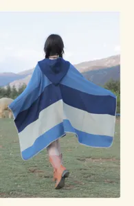 Back view of a stylish blue striped hooded poncho shawl for outdoor ethnic travel wear