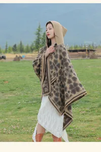 Bohemischer Strickschal mit Kapuze und Herzmuster, getragen von einem Modell auf der Wiese