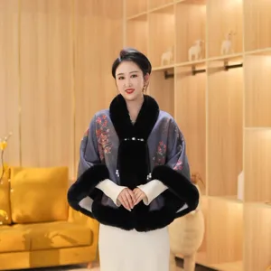 Elegantes Model trägt einen floralen Winterumhang mit schwarzem Kunstpelzkragen und Pelz.