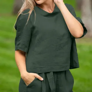 Detail view of women's dark green short sleeve crew neck top and casual trousers two piece set.