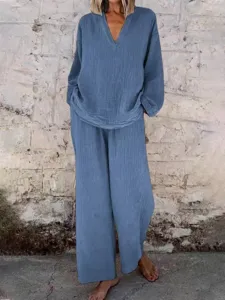 Detailed view of the solid color V-neck long sleeve top and loose wide leg pants set texture.