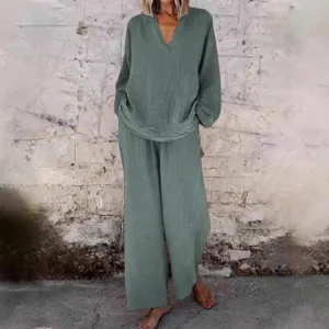 Casual solid color two-piece women's outfit featuring a loose V-neck top and wide-leg pants.