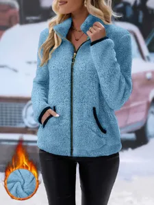 Fuzzy fleece zip-up jacket detail, cozy winter outerwear with high collar and pockets.