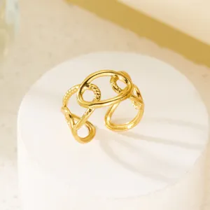 Detailansicht eines vergoldeten Edelstahlrings mit aufwendig verschlungenem Kreismuster.