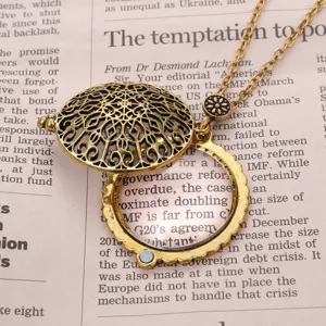 Detailed view of vintage hollow magnifying glass necklace showing 5x magnification effect