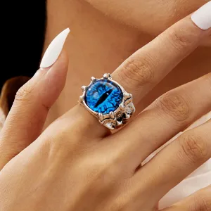 Macro detail showing the blue demon eye and claw setting of this punk style ring