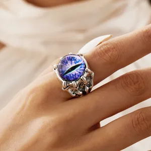 Close-up of vintage silver monster claw ring with purple dragon eye