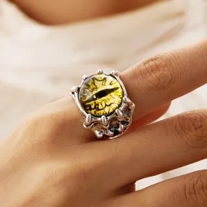 Detailed view of gothic demon claw ring featuring a yellow textured evil eye stone