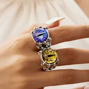 Detailed close-up showing silver-tone claw rings with vibrant blue and yellow devil's eyes