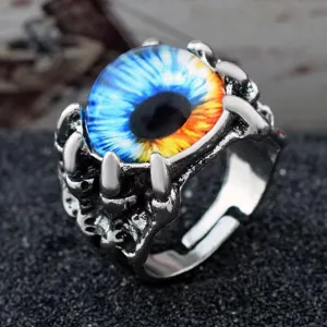 Detail view of a gothic punk dragon claw ring with a blue and orange devil's eye cabochon