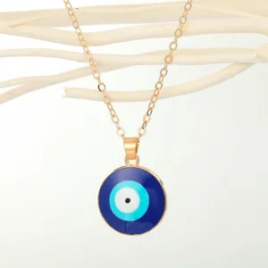 Detailed macro view of Turkish Evil Eye circular pendant with elegant gold chain