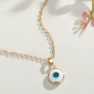 Detailed view of the gold-plated Turkish evil eye pendant with blue enamel inlay