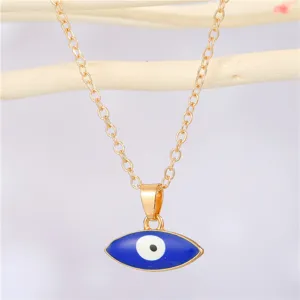 Macro detail of a gold-plated Turkish evil eye pendant necklace with blue enamel