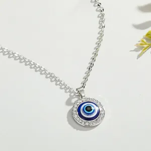 Detailed view of silver Evil Eye pendant necklace with sparkling crystal rhinestones.