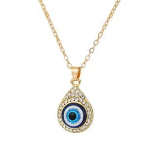 Golden chain necklace with a teardrop-shaped blue Evil Eye pendant and white crystals.
