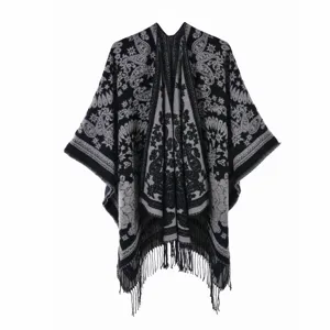 Detailed view of ethnic paisley pattern and fringe on a warm grey and black shawl