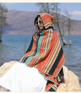 Outdoor lifestyle view of an ethnic hooded poncho with colorful knitted stripes
