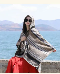 Detailed close-up view of ethnic colorful striped hooded knit poncho shawl worn by model