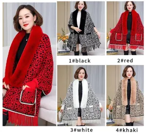 Detailed view of women's leopard print knit shawl with large faux fur collar and fringe