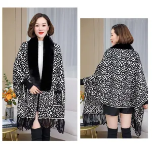 Front and back views of a black and white knit poncho with a large faux fur collar