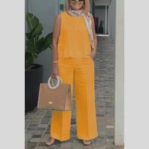 Detail view of women's sleeveless solid cotton linen top and wide leg pants set in bright yellow.