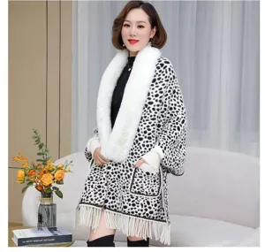 Detail view of stylish leopard print knitted poncho featuring a plush white faux fur collar