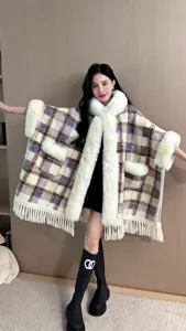 Eleganter karierter Kapuzen-Poncho mit Kunstpelzkragen und Fransen von Model getragen