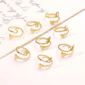 Close-up detail of stainless steel heart initial rings in elegant gold finish