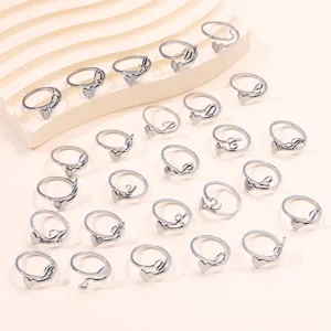 Detailed view of 26 alphabet heart open rings in polished stainless steel