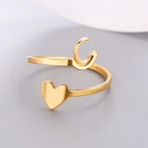 Macro detail of a minimalist gold-plated stainless steel initial 'C' heart open ring
