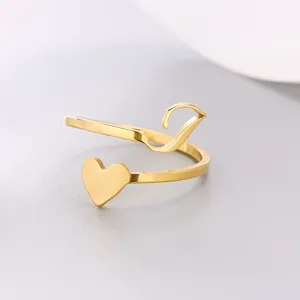 Close-up of gold heart and letter V open ring with smooth polished finish