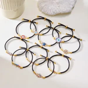 Close-up of adjustable Evil Eye and Hamsa cord bracelets in various styles and colors