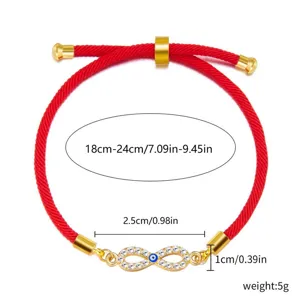 Detailed view of adjustable red cord bracelet with evil eye infinity charm