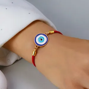 Detailed view of adjustable red string evil eye bracelet with blue enamel alloy pendant