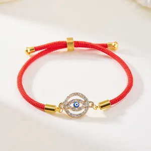 Detailed view of adjustable red cord Evil Eye bracelet with sparkling crystal pendant