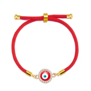 Close-up of a red cord Evil Eye bracelet featuring a sparkling crystal rhinestone border