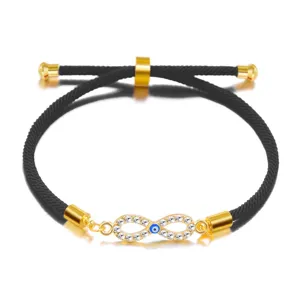 Close-up detail of adjustable black cord bracelet with crystal infinity evil eye charm