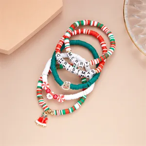 Dettaglio macro di braccialetti natalizi in argilla polimerica con ciondoli Babbo Natale