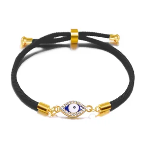 Detailed view of adjustable evil eye bracelet with rhinestones and black rope.