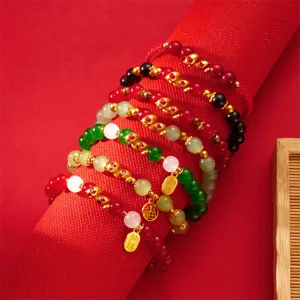 Detailed view of Chinese zodiac snake bracelets with colorful beads and gold charms