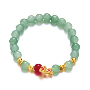 Close-up detail of Chinese zodiac snake bracelet with green beads and gold charms