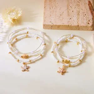 Bohemian layered beaded necklace featuring white starfish and gold shell charms for summer
