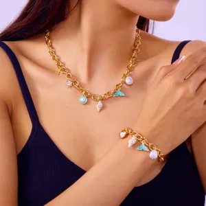 Ocean-themed chunky gold necklace and bracelet set with shell and mermaid tail charms