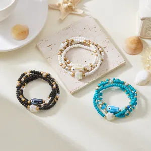 Set de 4 pulseras de cuentas de playa con dijes de peces de cerámica y conchas para mujer